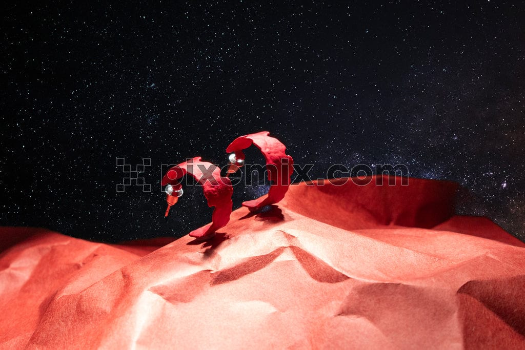 Red ring on a stone with galaxy background image.