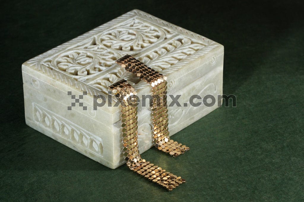 Gold bracelet on traditional box image.