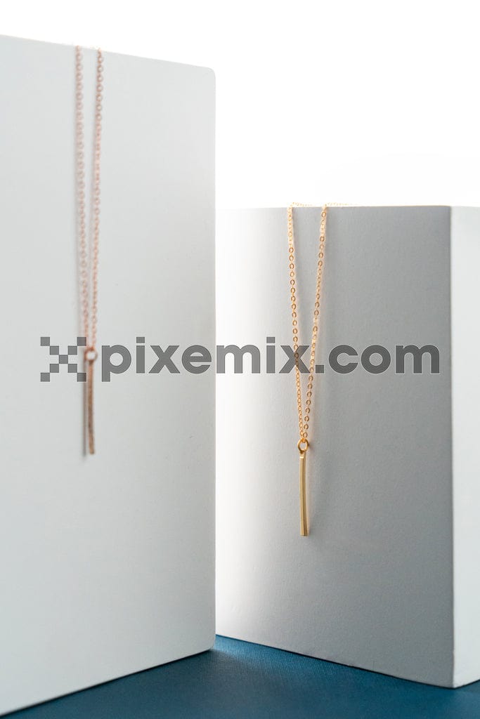 Gold chain on white podium box image.