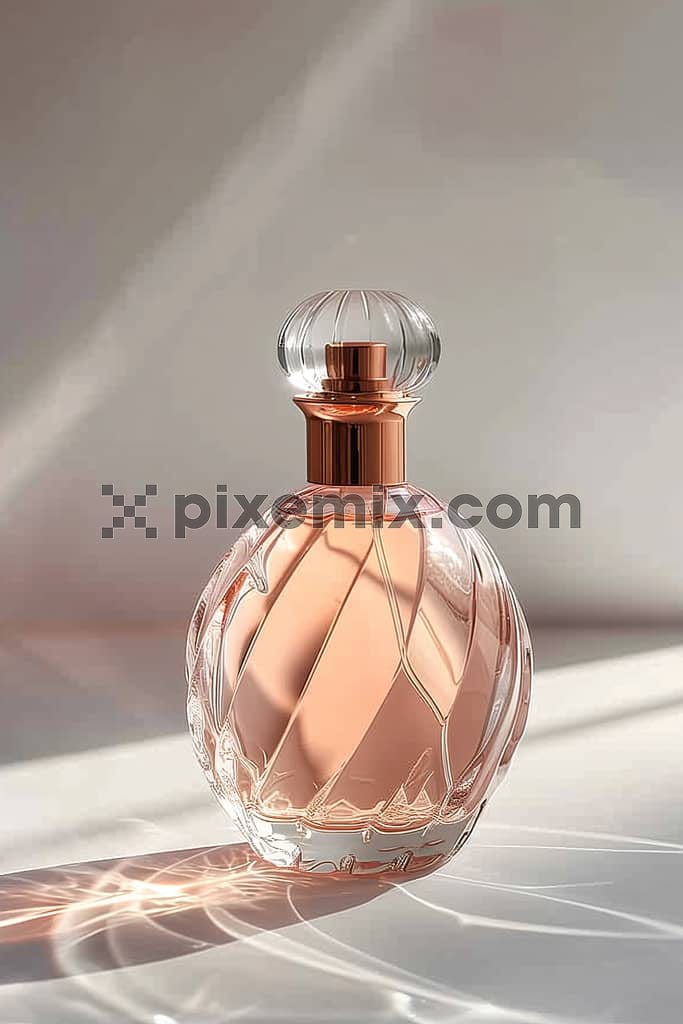 A beautiful image of a perfume in a spherical rose gold bottle.