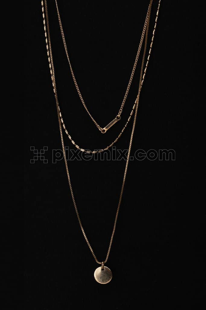 An image of a three layered golden necklace.