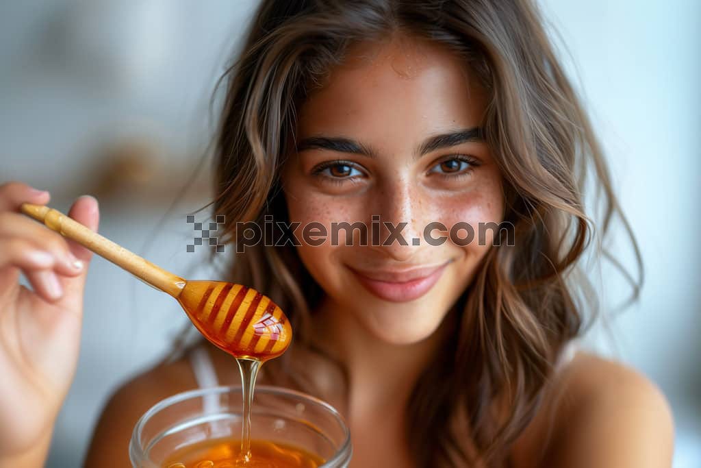 An image of  very lively woman holding a jar of honey feeling happy.