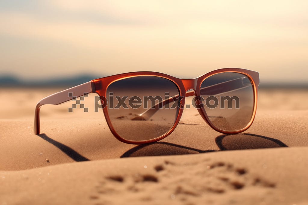 The image shows a close-up of sunglasses golden desert sands.